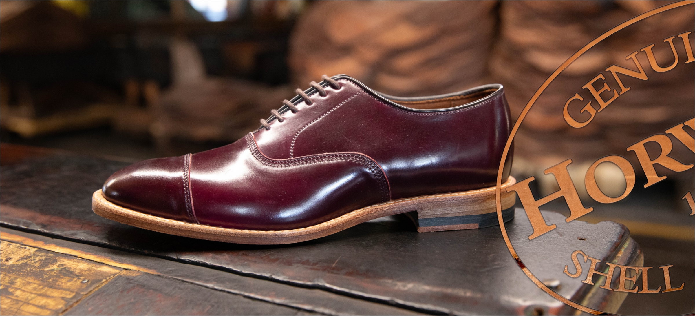 A men’s burgundy dress shoe displayed at an angle. 