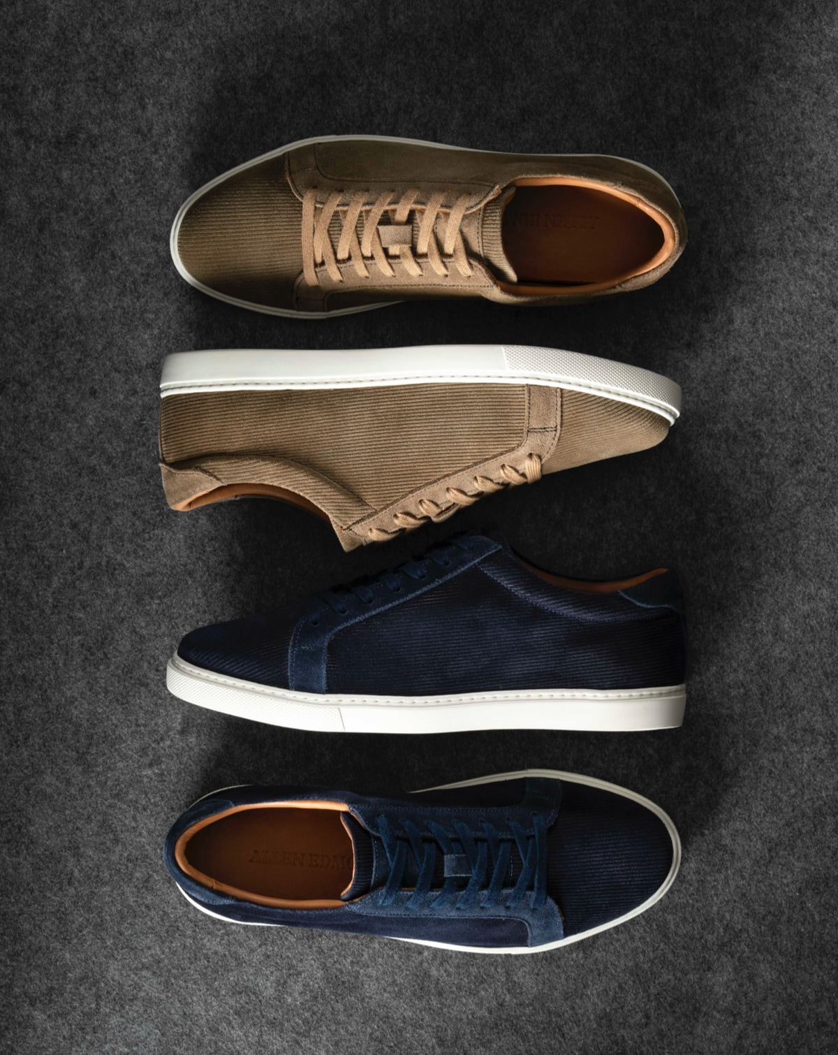 Two pairs of Allen Edmonds Courtside Lace Up Sneakers displayed next to each other, one in tan corduroy and the other in navy blue corduroy.