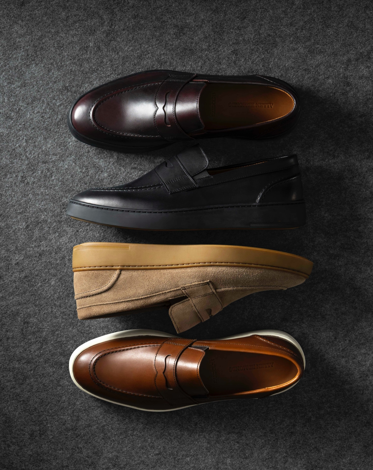 Four single Allen Edmonds Randolph 2.0 Penny Loafers in various colors displayed next to one another.