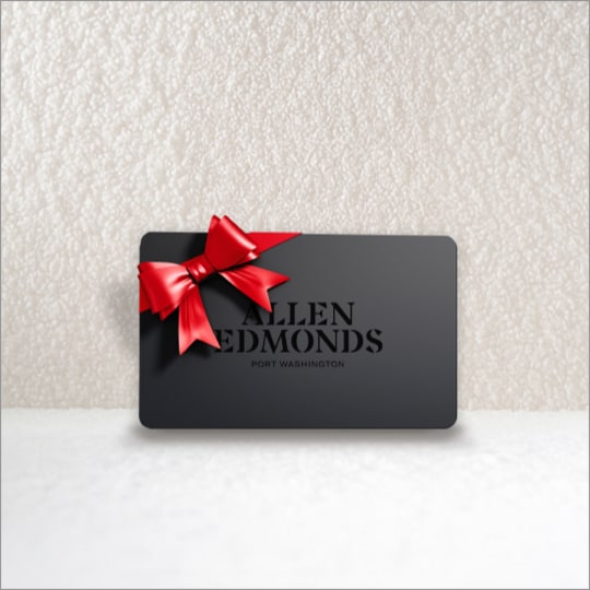 A black Allen Edmonds gift card with a red bow on the top left corner.  