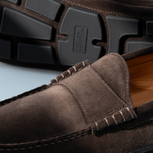 Men’s gray textured leather sneaker with tan rubber sole and brown leather lining