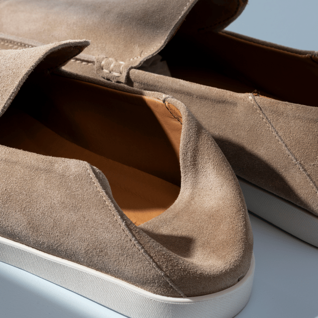 Men’s gray textured leather sneaker with tan rubber sole and brown leather lining
