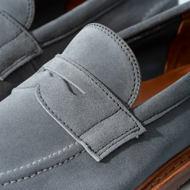 Men’s gray textured leather sneaker with tan rubber sole and brown leather lining