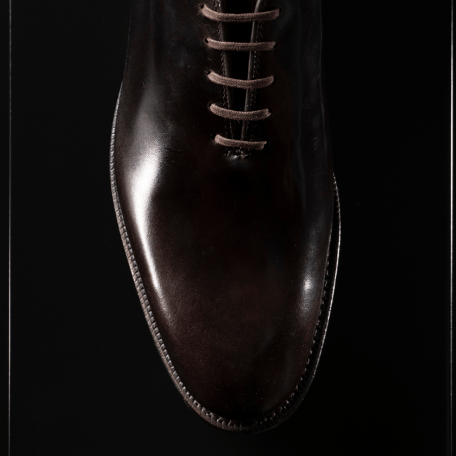 Men’s gray textured leather sneaker with tan rubber sole and brown leather lining