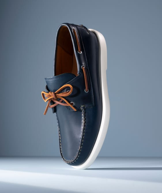 Men’s gray textured leather sneaker with tan rubber sole and brown leather lining