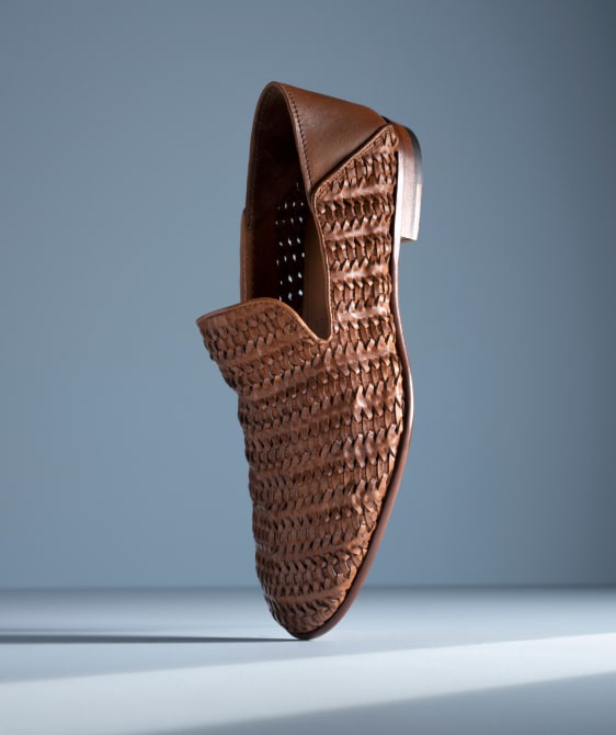 Men’s gray textured leather sneaker with tan rubber sole and brown leather lining