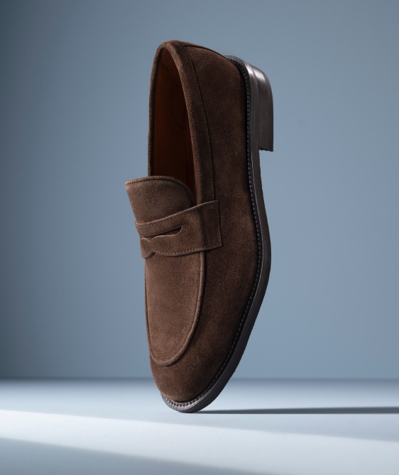 Men’s gray textured leather sneaker with tan rubber sole and brown leather lining