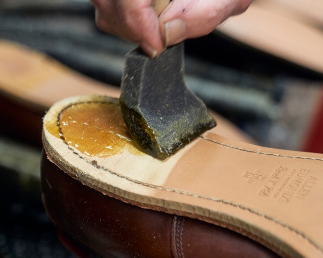 Old heels removed and adhesive applied to outsoles