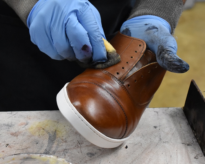Polish applied to uppers for final refinishing
