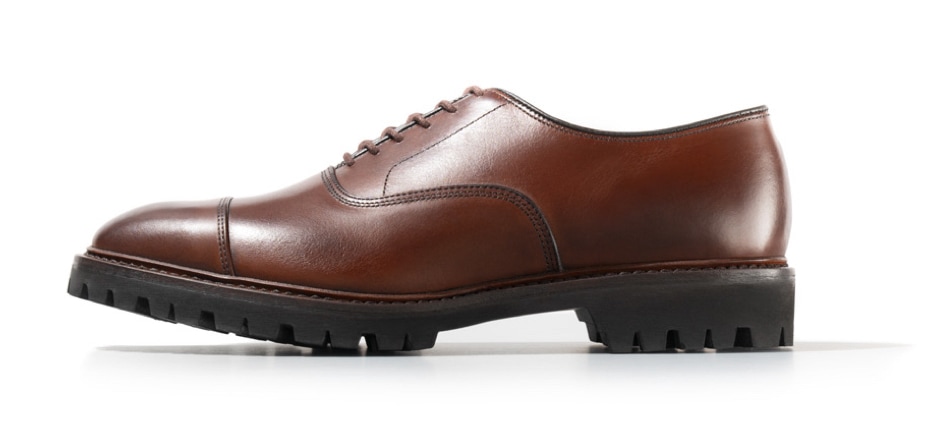 Brown cap-toe oxford dress shoe with lug sole