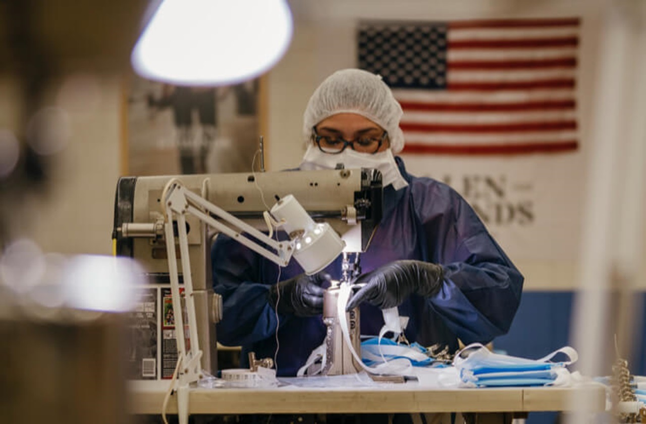 An Allen Edmonds craftsperson making facemasks in 2020