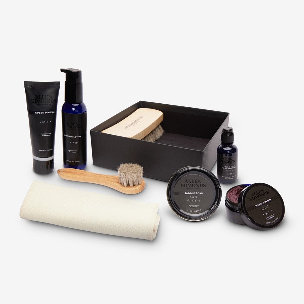 Complete Allen Edmonds shoe care kit with polish, brushes, and cleaning accessories